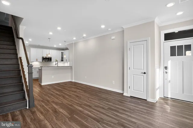a view of an entryway with wooden floor and windows