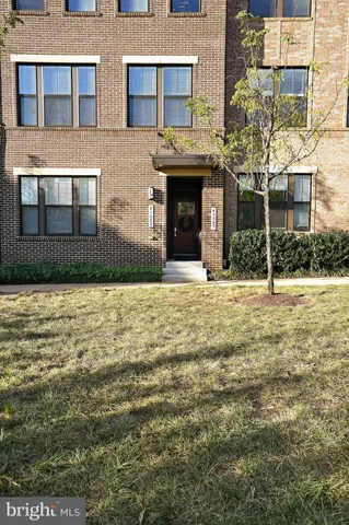a front view of a building with a garden
