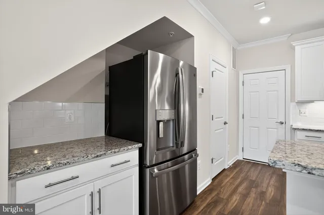 a kitchen with stainless steel appliances granite countertop a sink stove and microwave
