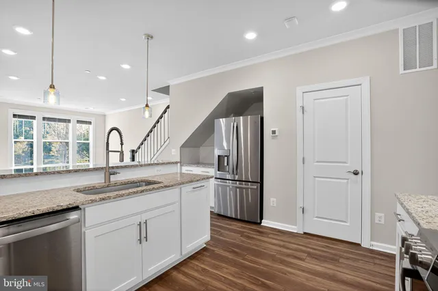 a kitchen with sink and refrigerator