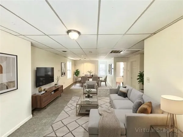 a living room with furniture and a flat screen tv