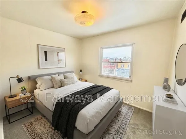 a bedroom with a bed and a painting on the wall