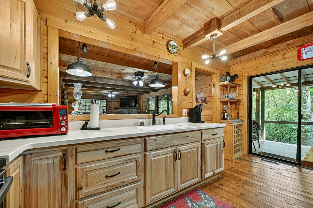 1431 Cashes Valley Lane Cherry Log, GA 30522 - Photo 20 of 57 a kitchen with stainless steel appliances granite countertop a sink and wooden cabinets