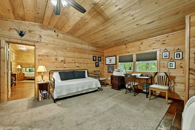 a bedroom with furniture and large windows
