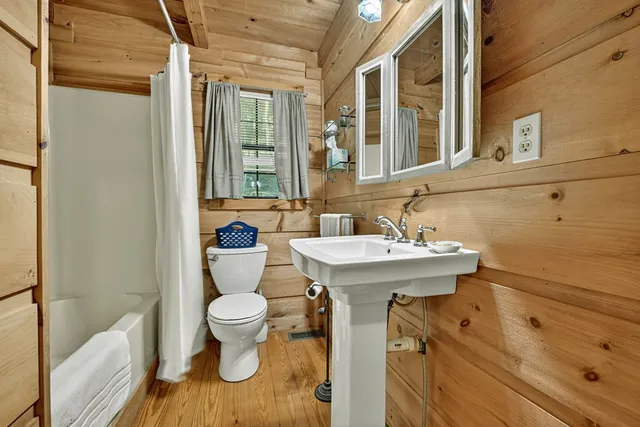 a view of a yard with plants and wooden fence