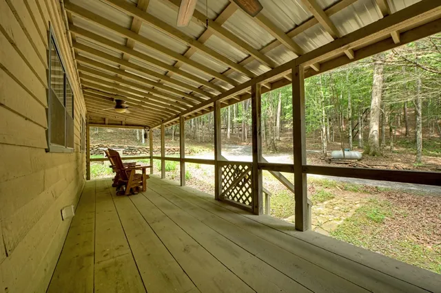 a view of a small house with backyard