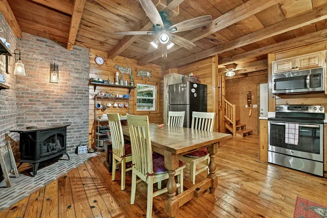 a dining room with furniture a flat screen tv and a fireplace