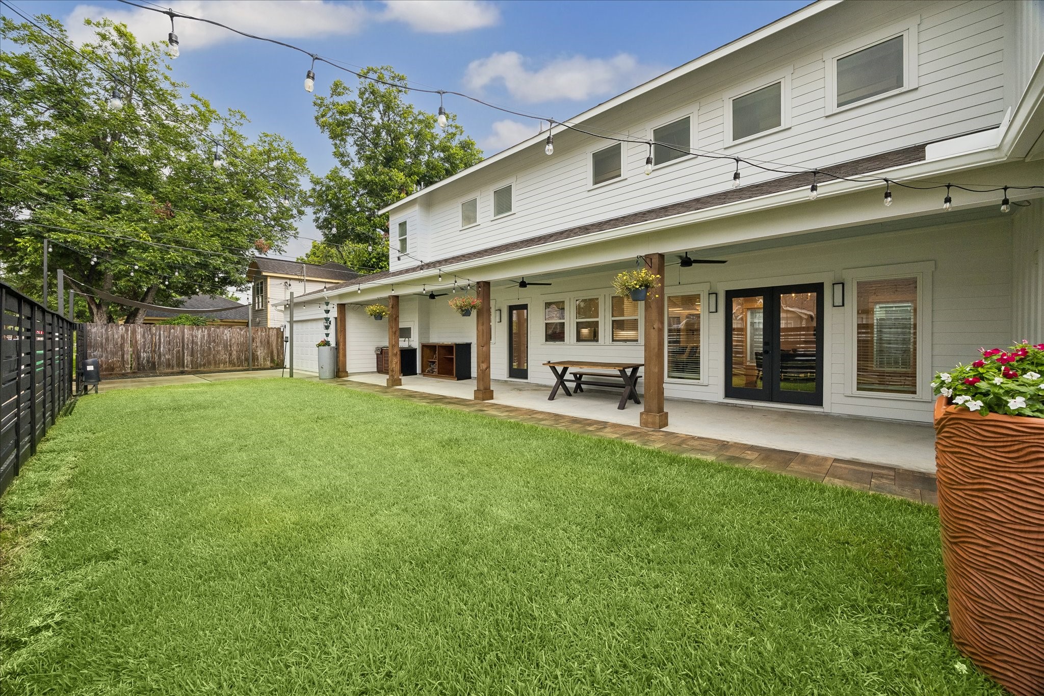 1205 Temple Street Houston, TX 77009 - Photo 4 of 33 An oversized yard adjacent to a thoughtfully extended patio extends the living space outdoors, offering endless opportunities—from weekend gatherings and playtime to future outdoor living enhancements.