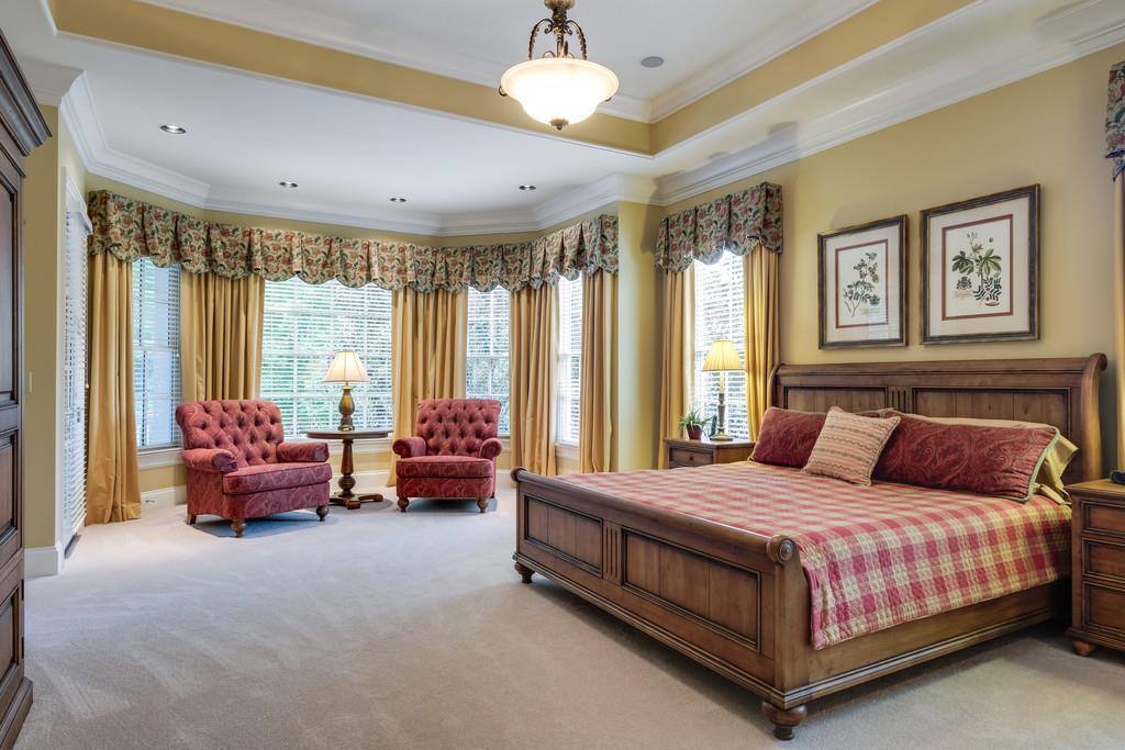 1201 Talon Way Franklin, TN 37069 - Photo 16 of 30 a bedroom with a bed and a chandelier