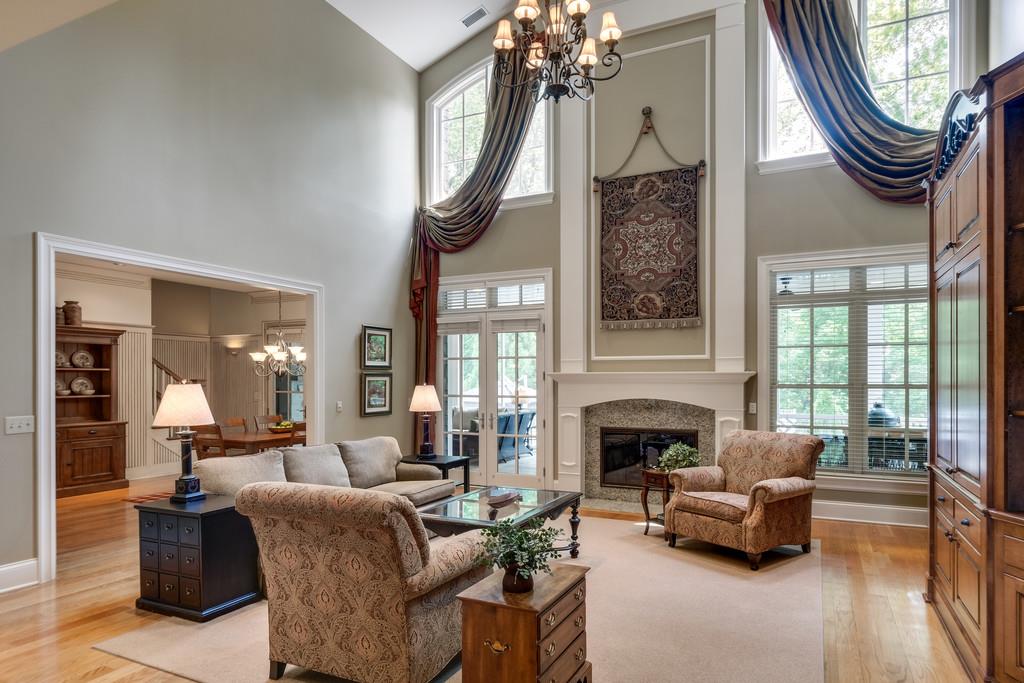 1201 Talon Way Franklin, TN 37069 - Photo 8 of 30 a living room with furniture a fireplace and a chandelier