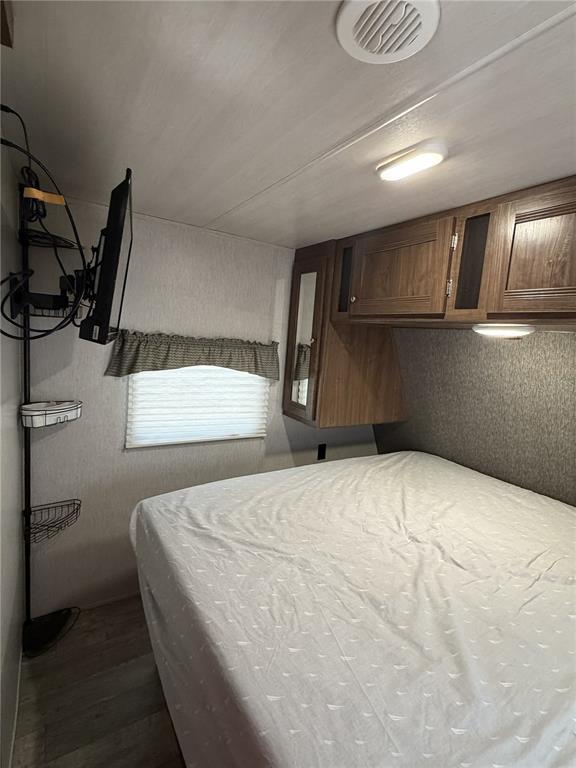 3000 Clarcona Road, Unit 743 Apopka, FL 32703 - Photo 31 of 54 a bedroom with a bed and cabinets