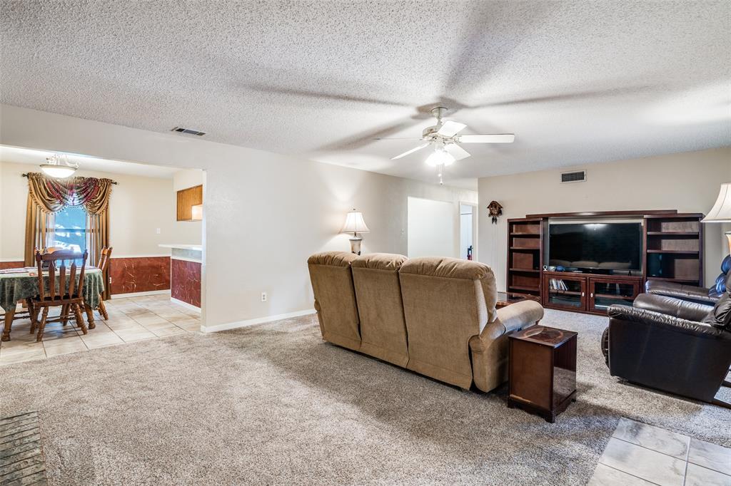 805 Paul Wilson Road Wylie, TX 75098 - Photo 37 of 38 The spacious living room opens to the dining area for a flowing floor plan.