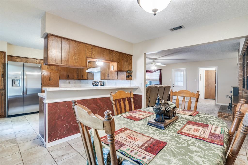 805 Paul Wilson Road Wylie, TX 75098 - Photo 38 of 38 The flow of the floorplan allows for easy access between the kitchen and living room.