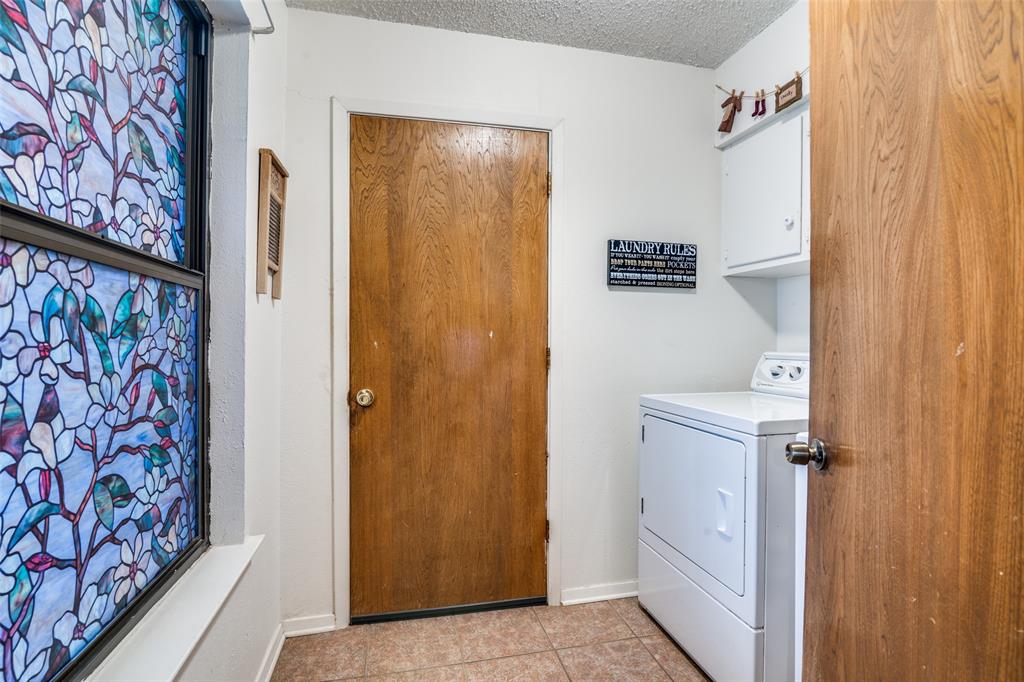 805 Paul Wilson Road Wylie, TX 75098 - Photo 26 of 38 Utility room leads to the garage and has room for your full size washer-dryer and cabinets for storage.