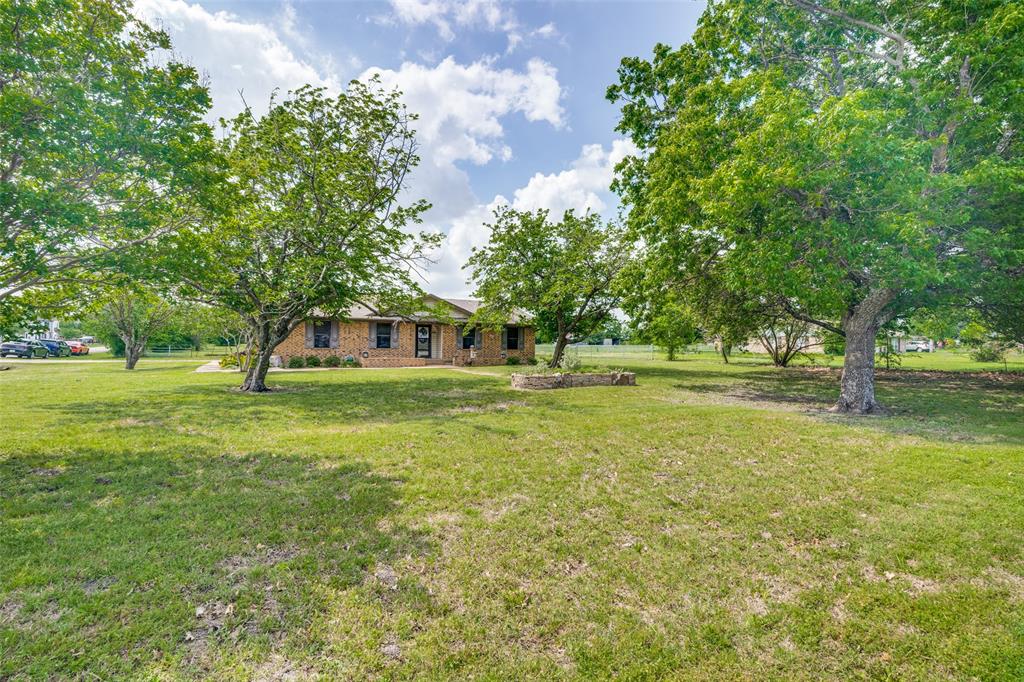 805 Paul Wilson Road Wylie, TX 75098 - Photo 29 of 38 Beautiful trees welcome you, the custom planter box provides space for your favorite flowers and plants, with in-town acreage that makes you feel right at home.