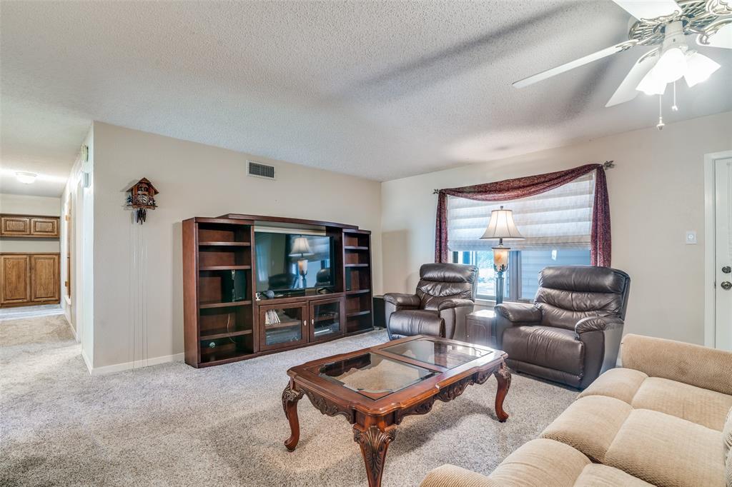 805 Paul Wilson Road Wylie, TX 75098 - Photo 5 of 38 Large entryway leads to the family room includes a wood burning fireplace.