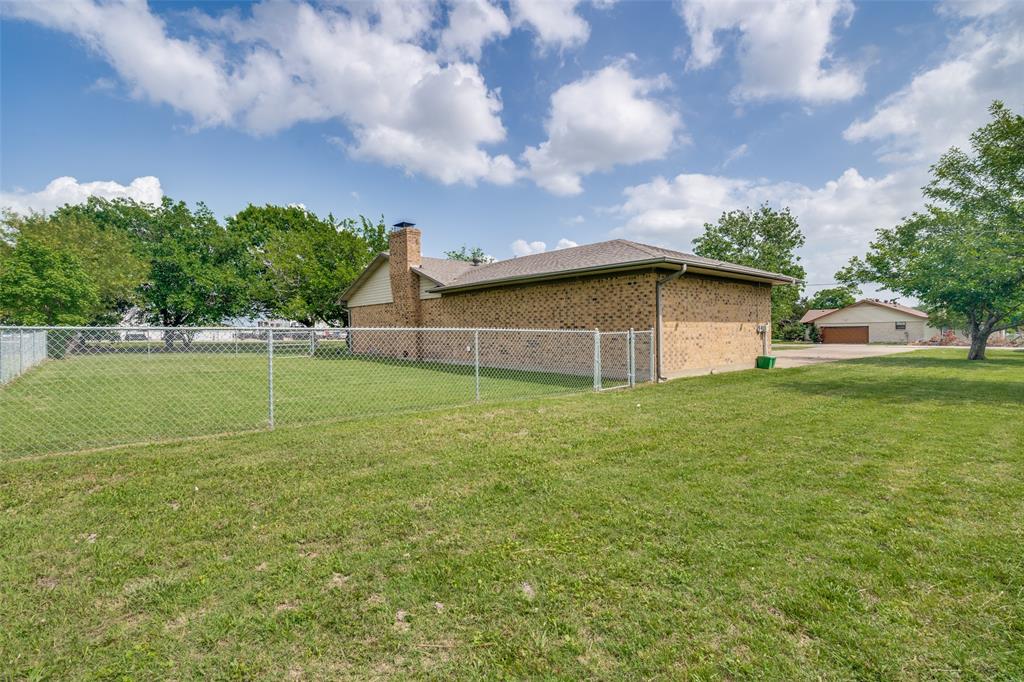 805 Paul Wilson Road Wylie, TX 75098 - Photo 7 of 38 Fenced backyard area for pets and partially fenced acreage with a barn.