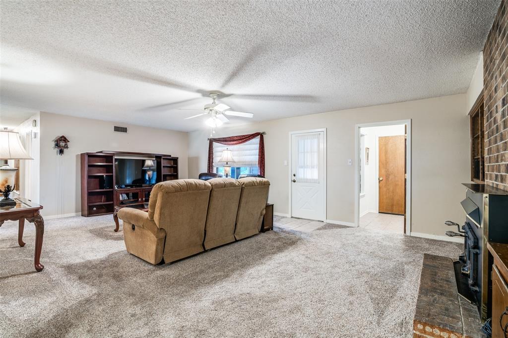 805 Paul Wilson Road Wylie, TX 75098 - Photo 10 of 38 Spacious entry way leads to the large family room with brick wood burning fireplace.