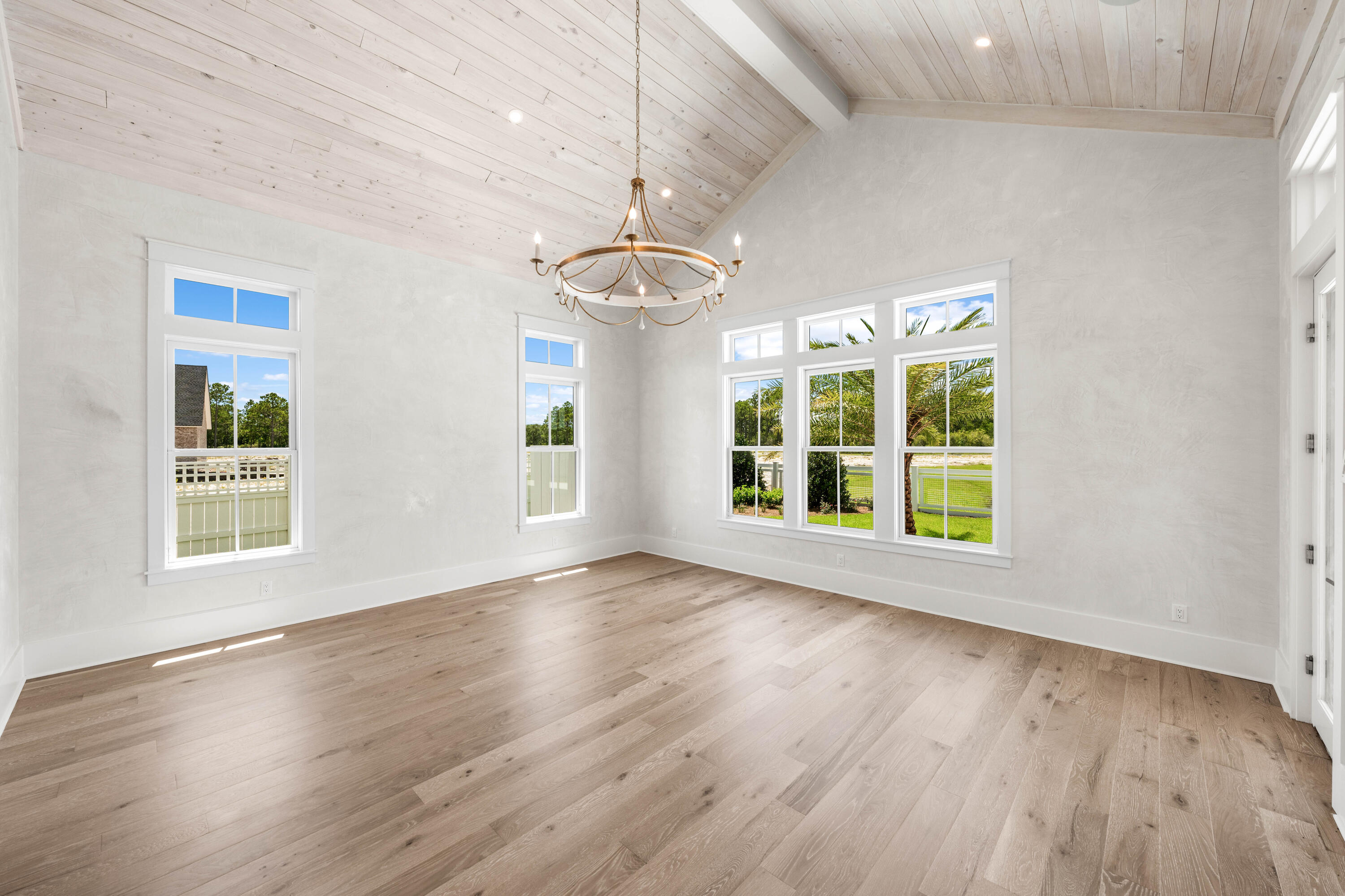 65 Morning Lgt Way Watersound, FL 32461 - Photo 16 of 59 a view of an empty room with wooden floor and a window