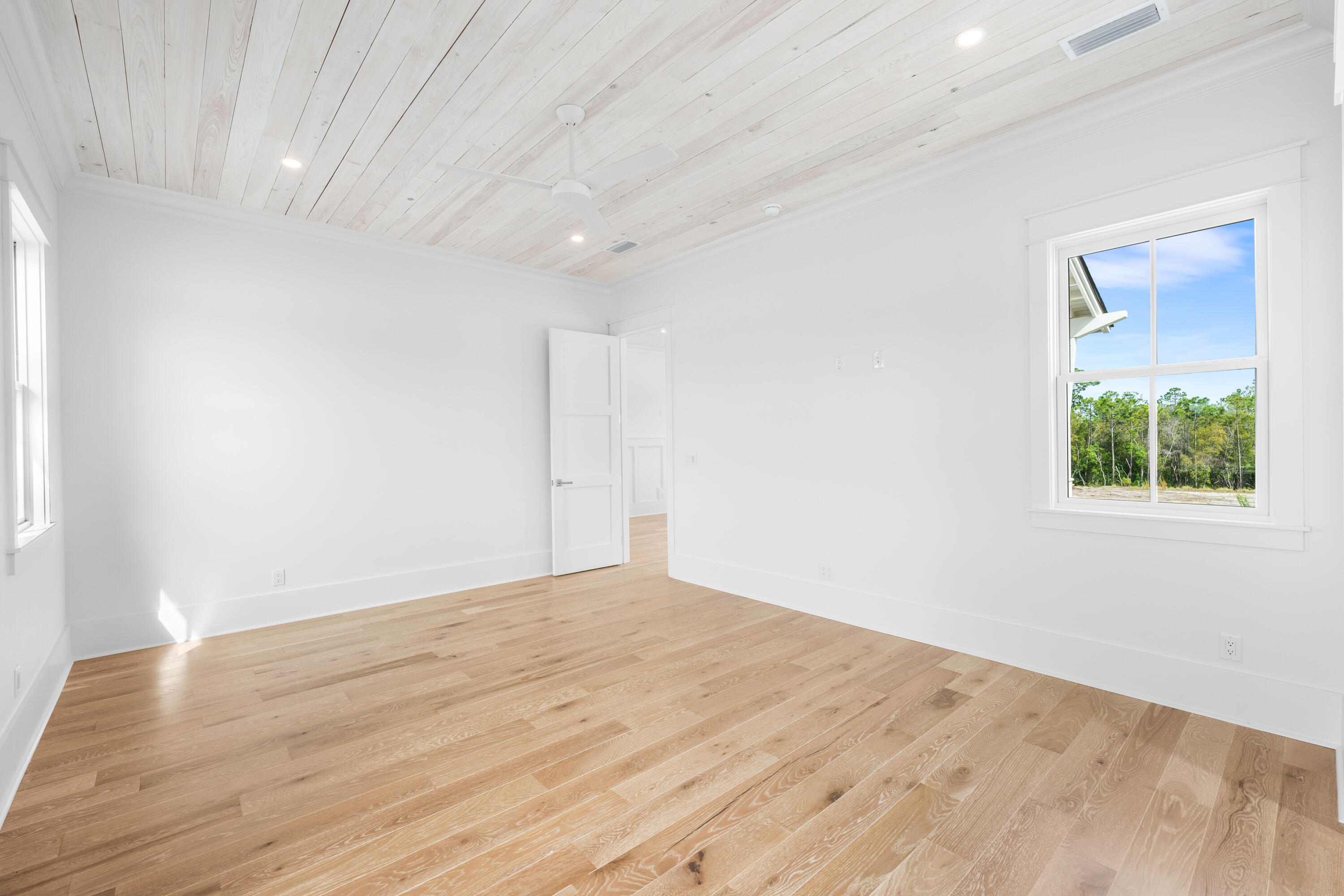 65 Morning Lgt Way Watersound, FL 32461 - Photo 34 of 59 a view of an empty room with wooden floor and a window