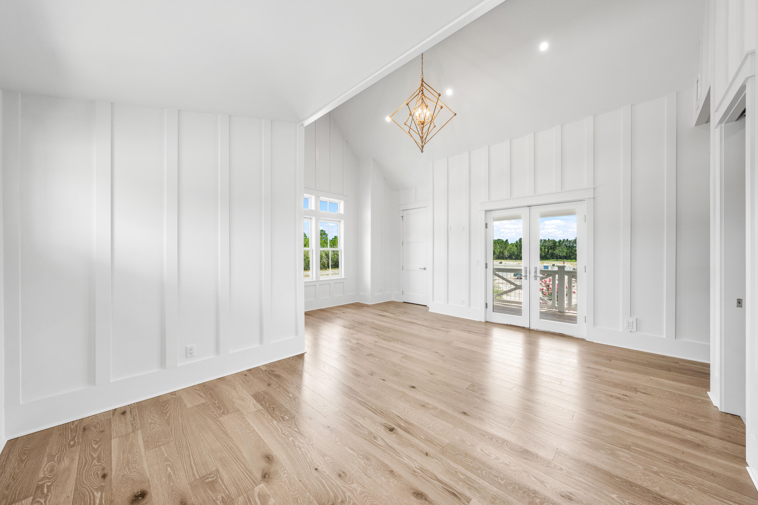 65 Morning Lgt Way Watersound, FL 32461 - Photo 40 of 59 a view of an empty room with wooden floor and a window