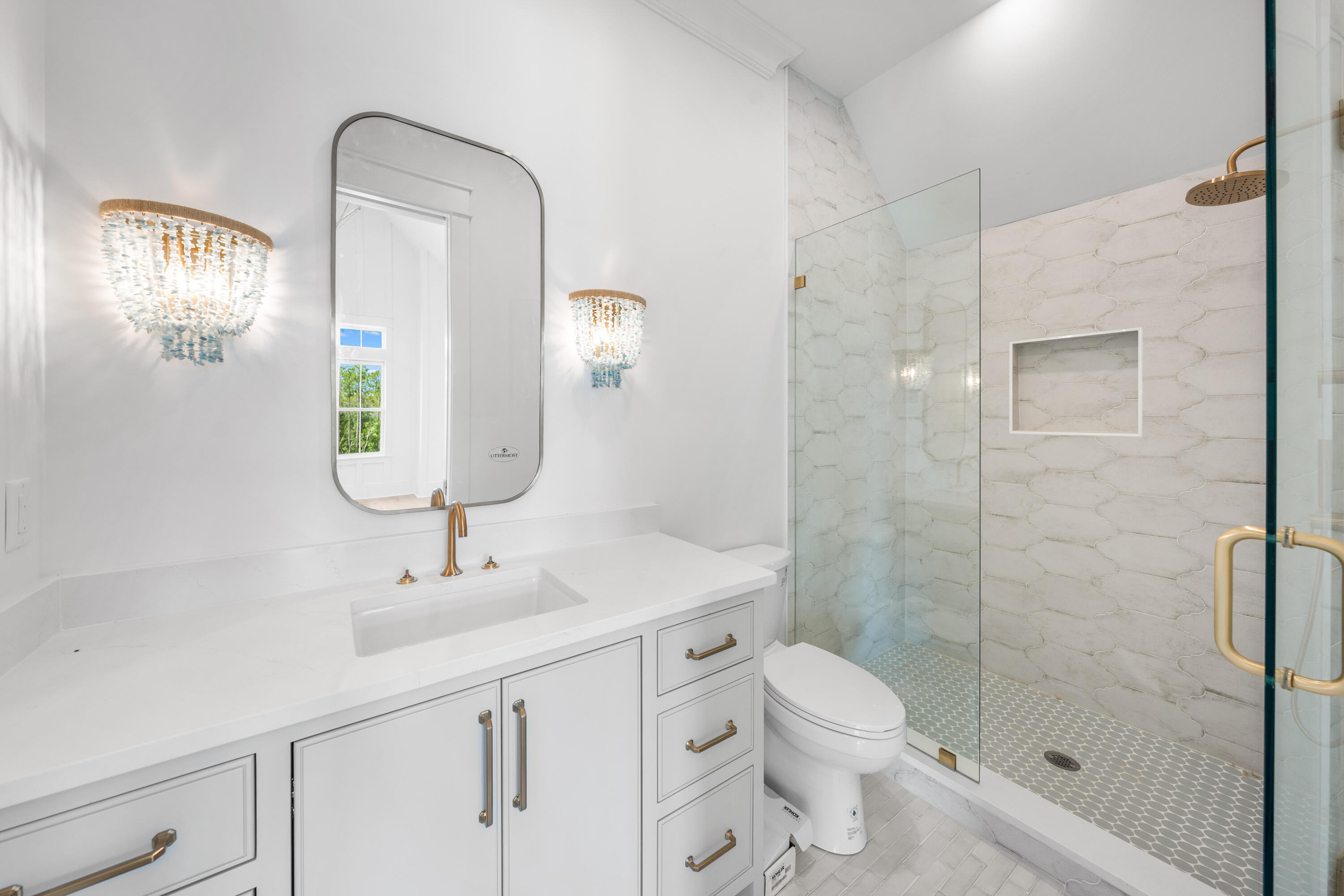 65 Morning Lgt Way Watersound, FL 32461 - Photo 41 of 59 a bathroom with a toilet a sink a glass door a shower a mirror and vanity