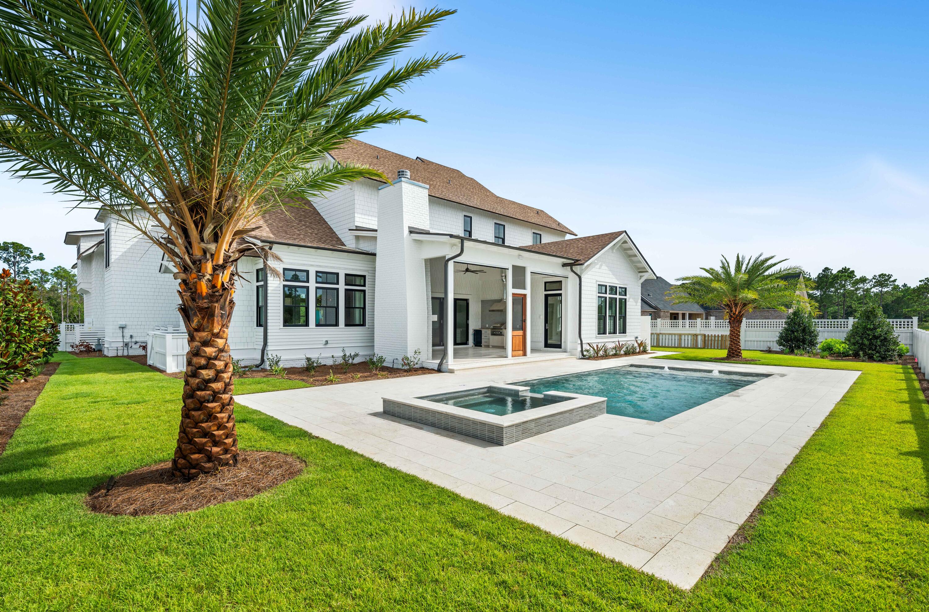 65 Morning Lgt Way Watersound, FL 32461 - Photo 58 of 59 a front view of a house with garden and trees