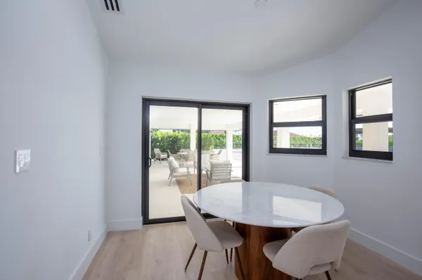 a view of a dining room with furniture and a window