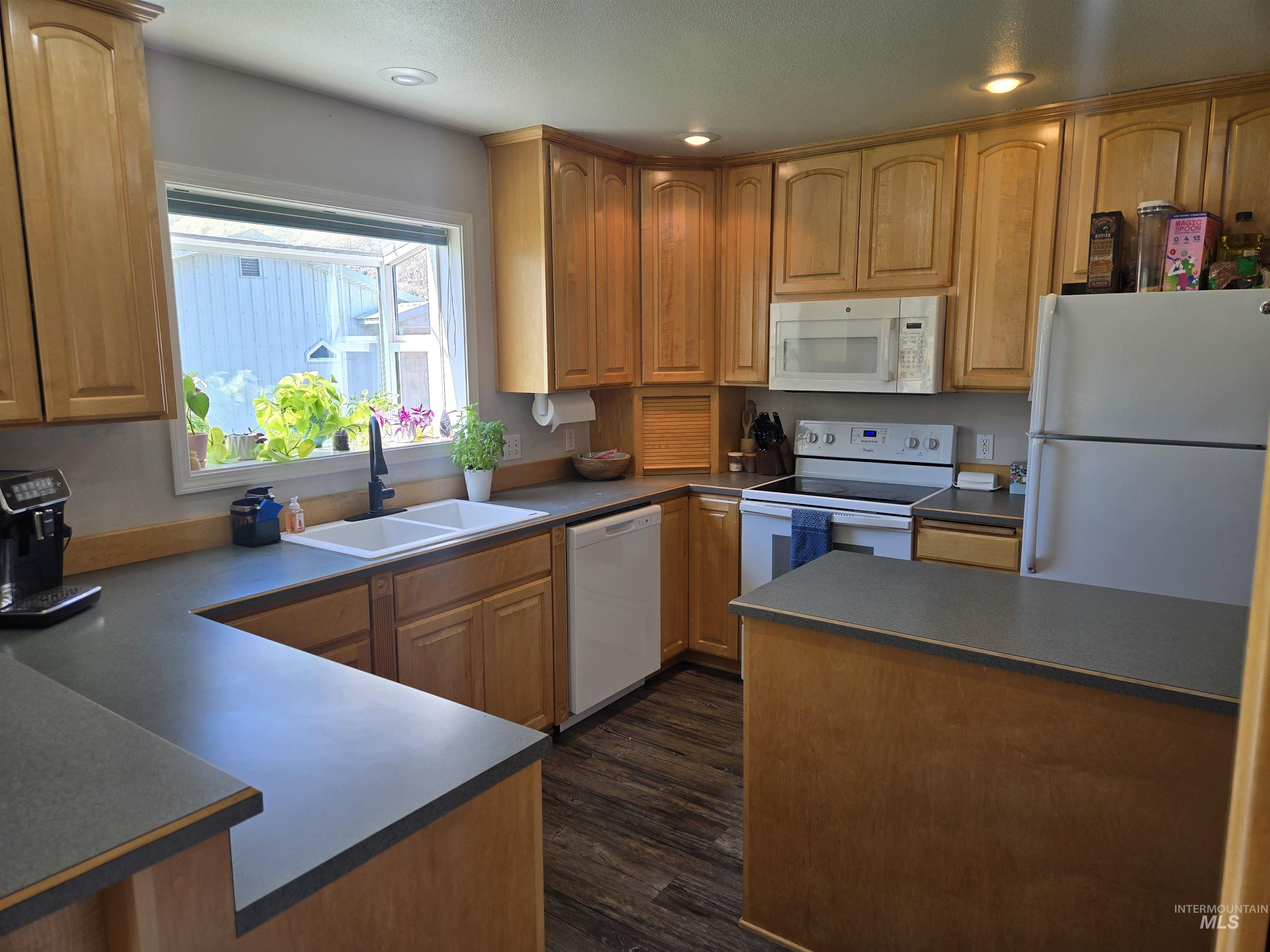 17082 Snake River Road Asotin, WA 99402 - Photo 26 of 31 Kitchen featuring white appliances, recessed lighting, a peninsula, and dark wood-style floors