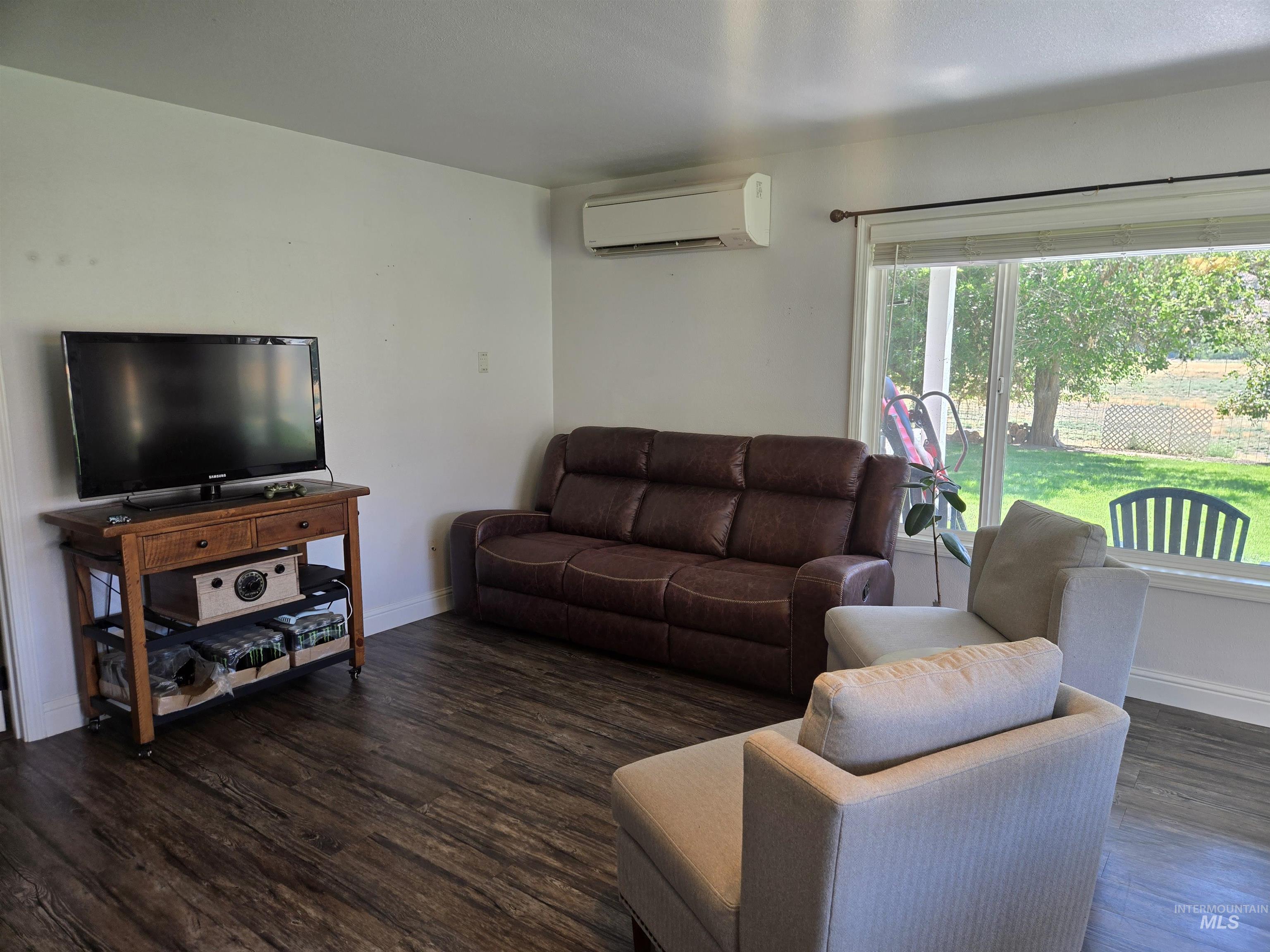17082 Snake River Road Asotin, WA 99402 - Photo 30 of 31 Living room featuring dark wood-style flooring and an AC wall unit