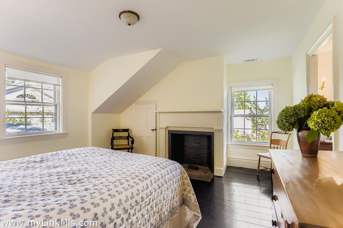 27 Spring Street Vineyard Haven, MA 02568 - Photo 40 of 58 a bedroom with a bed and a fireplace