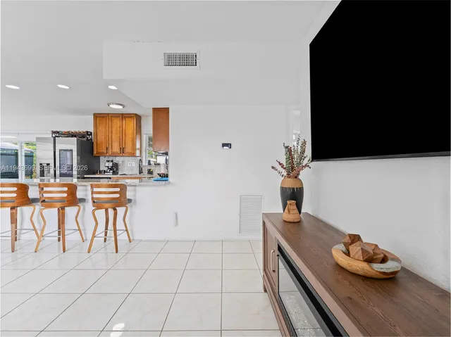 a kitchen with stainless steel appliances granite countertop a sink and a white cabinets