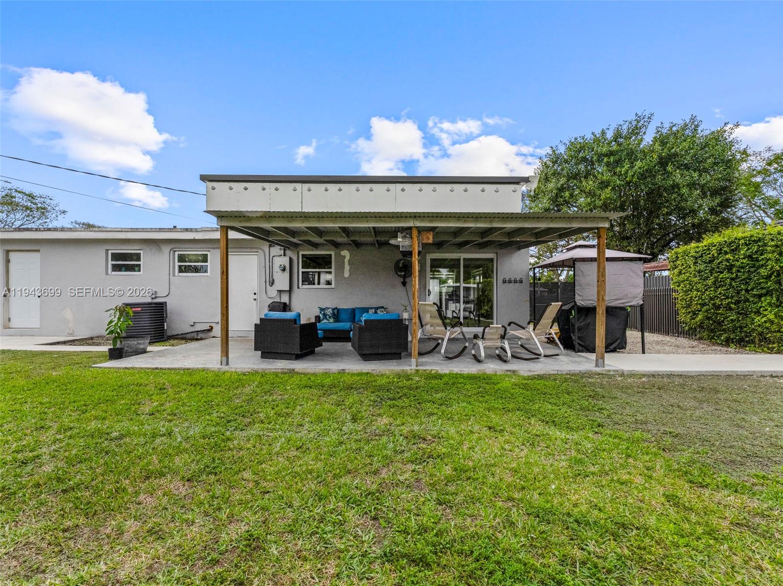 11401 Southwest 56th Street Miami, FL 33165 - Photo 22 of 37 a view of a house with backyard porch and furniture