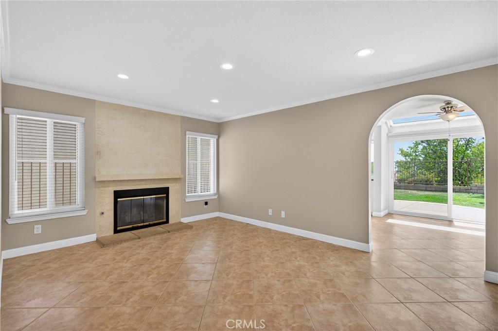 19468 Kilfinan Street Porter Ranch, CA 91326 - Photo 11 of 48 a view of an empty room with a fireplace and a window