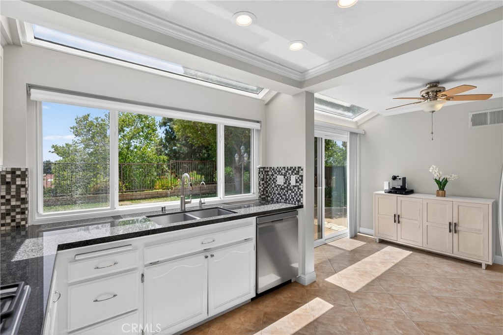 19468 Kilfinan Street Porter Ranch, CA 91326 - Photo 17 of 48 a large white kitchen with a large window appliances and cabinets