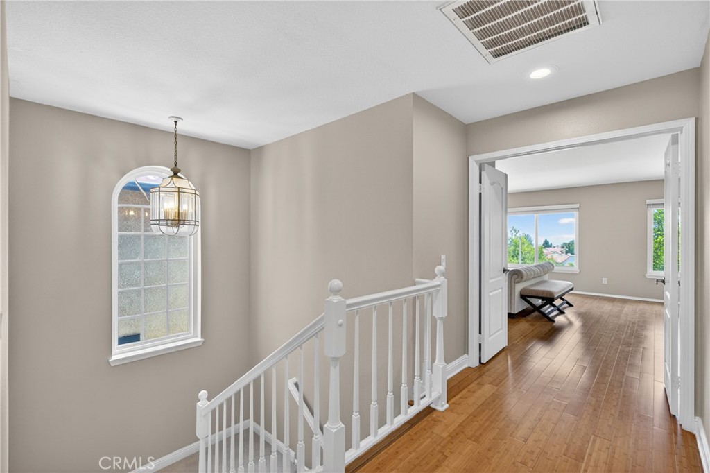 19468 Kilfinan Street Porter Ranch, CA 91326 - Photo 23 of 48 a hallway with wooden floor windows and a livingroom