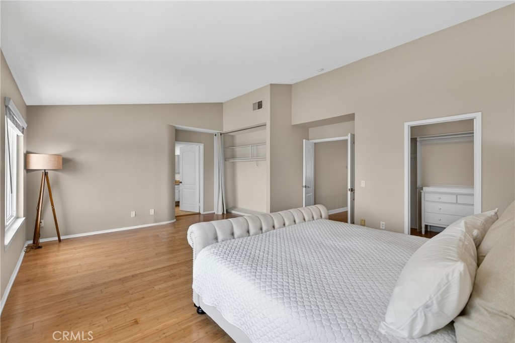 19468 Kilfinan Street Porter Ranch, CA 91326 - Photo 26 of 48 a bedroom with a bed and a large mirror