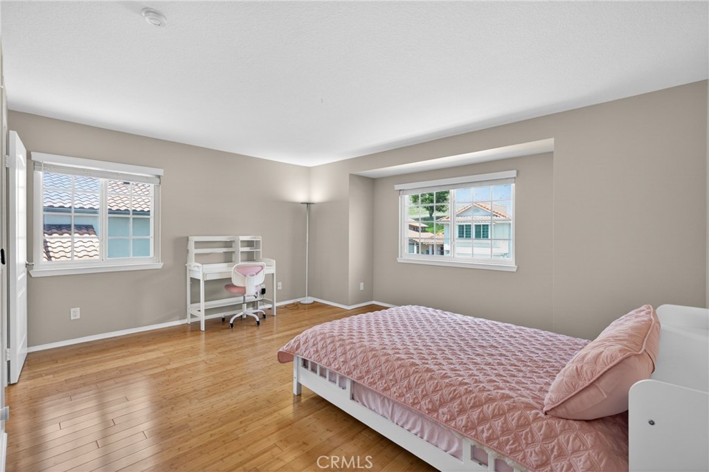19468 Kilfinan Street Porter Ranch, CA 91326 - Photo 32 of 48 a bedroom with a bed and a window