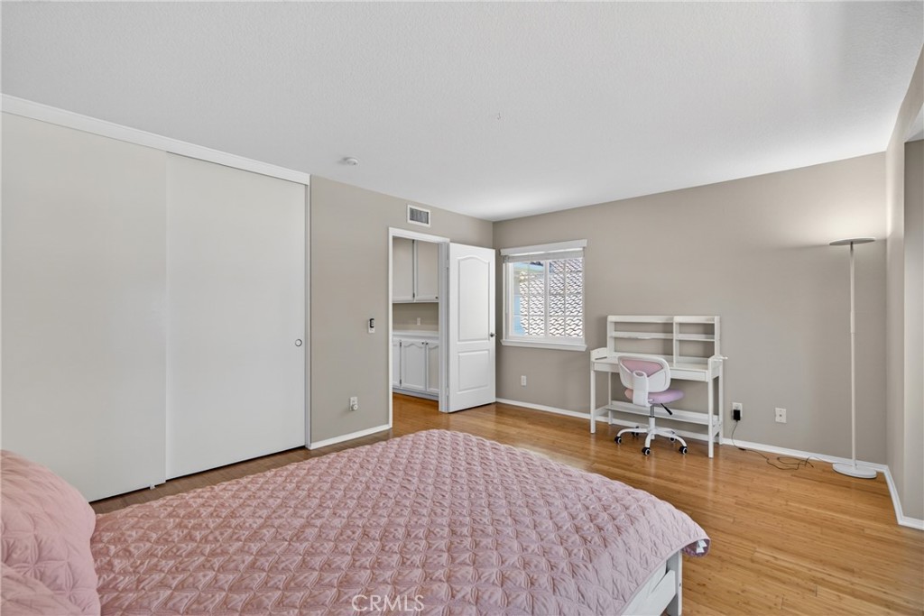 19468 Kilfinan Street Porter Ranch, CA 91326 - Photo 33 of 48 a bedroom with a bed and a chair in it