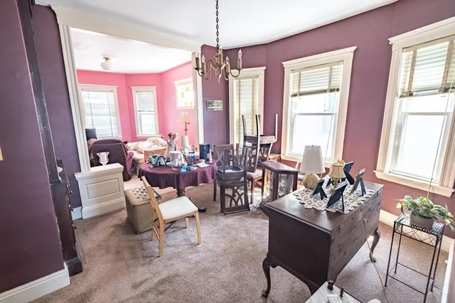 a living room with furniture and floor to ceiling windows