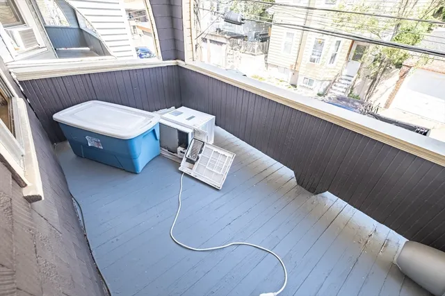 a view of a balcony with furniture and window