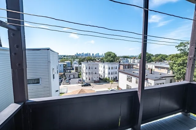 a view of a bathroom with a sink and mirror next to a window