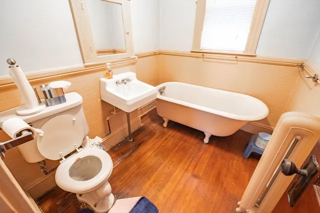 a bathroom with a sink mirror vanity and toilet