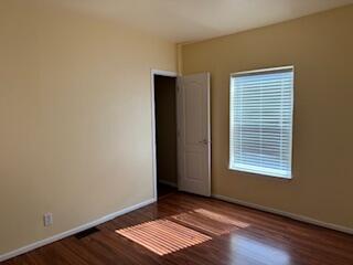 355 Colver Road, Unit 24 Talent, OR 97540 - Photo 17 of 21 a view of an empty room with wooden floor and a window