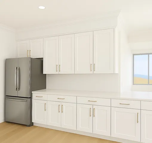 a kitchen with white cabinets and a refrigerator