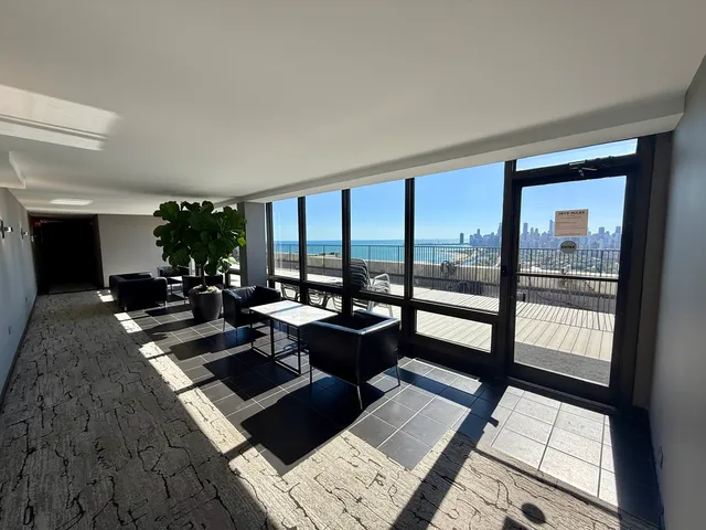 a living room with furniture and floor to ceiling windows