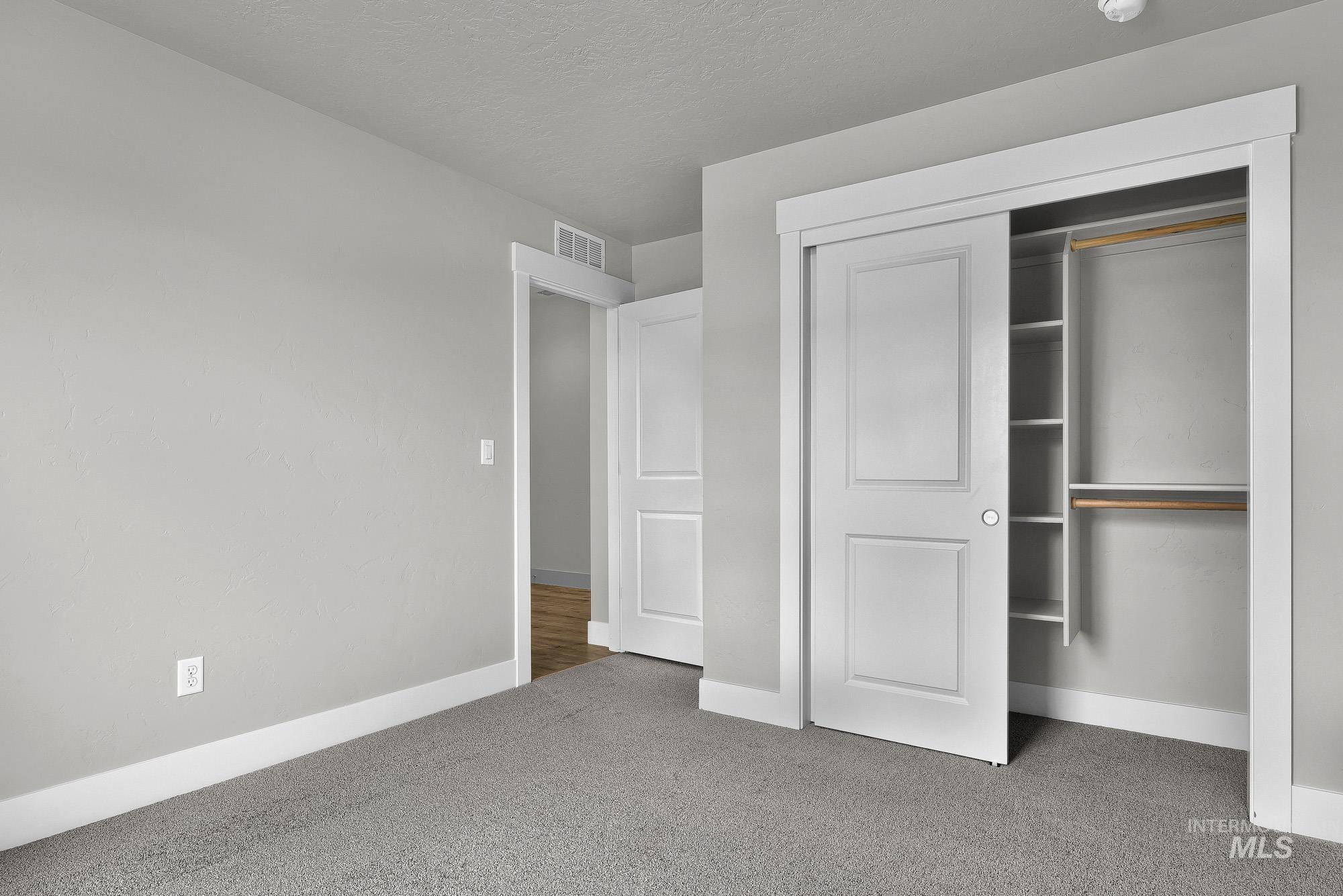 320 North 12th Parma, ID 83660 - Photo 11 of 34 Sliding closet doors revealing built-in shelving and hanging rods