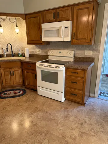 a kitchen with a refrigerator and cabinets