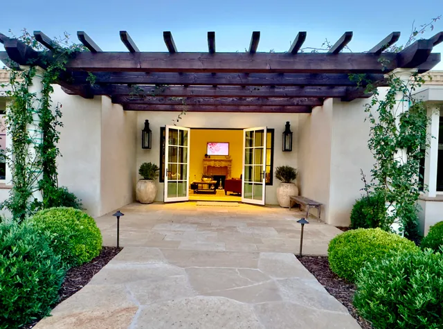 a view of a patio with a table and chairs and potted plants