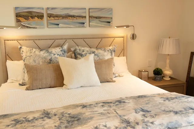 a large bed sitting in a bedroom next to a bathroom